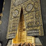 Muslim pilgrims gather in reverence at the Kaaba's golden door in Mecca, Saudi Arabia.